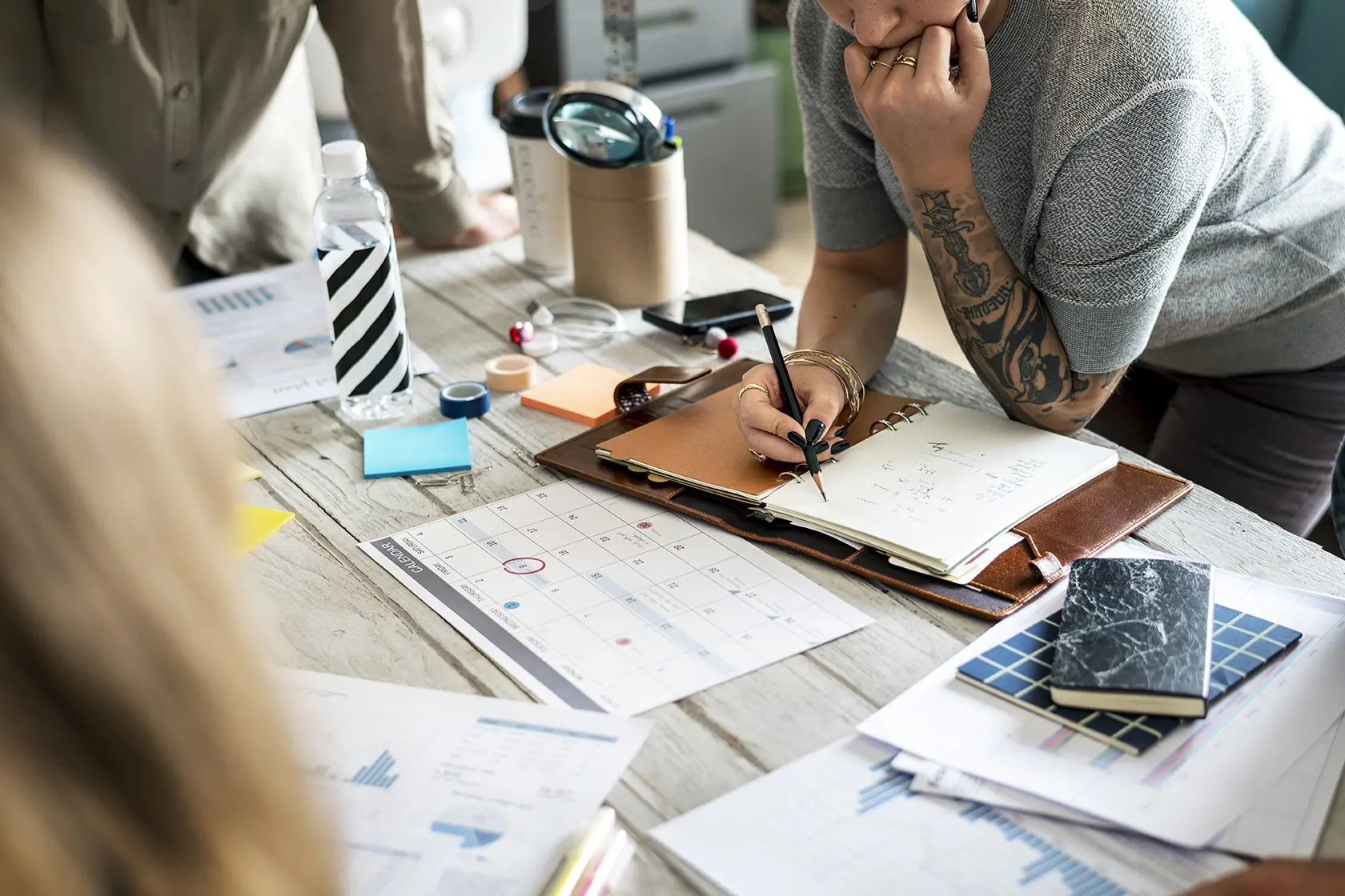 Tattooed woman planning